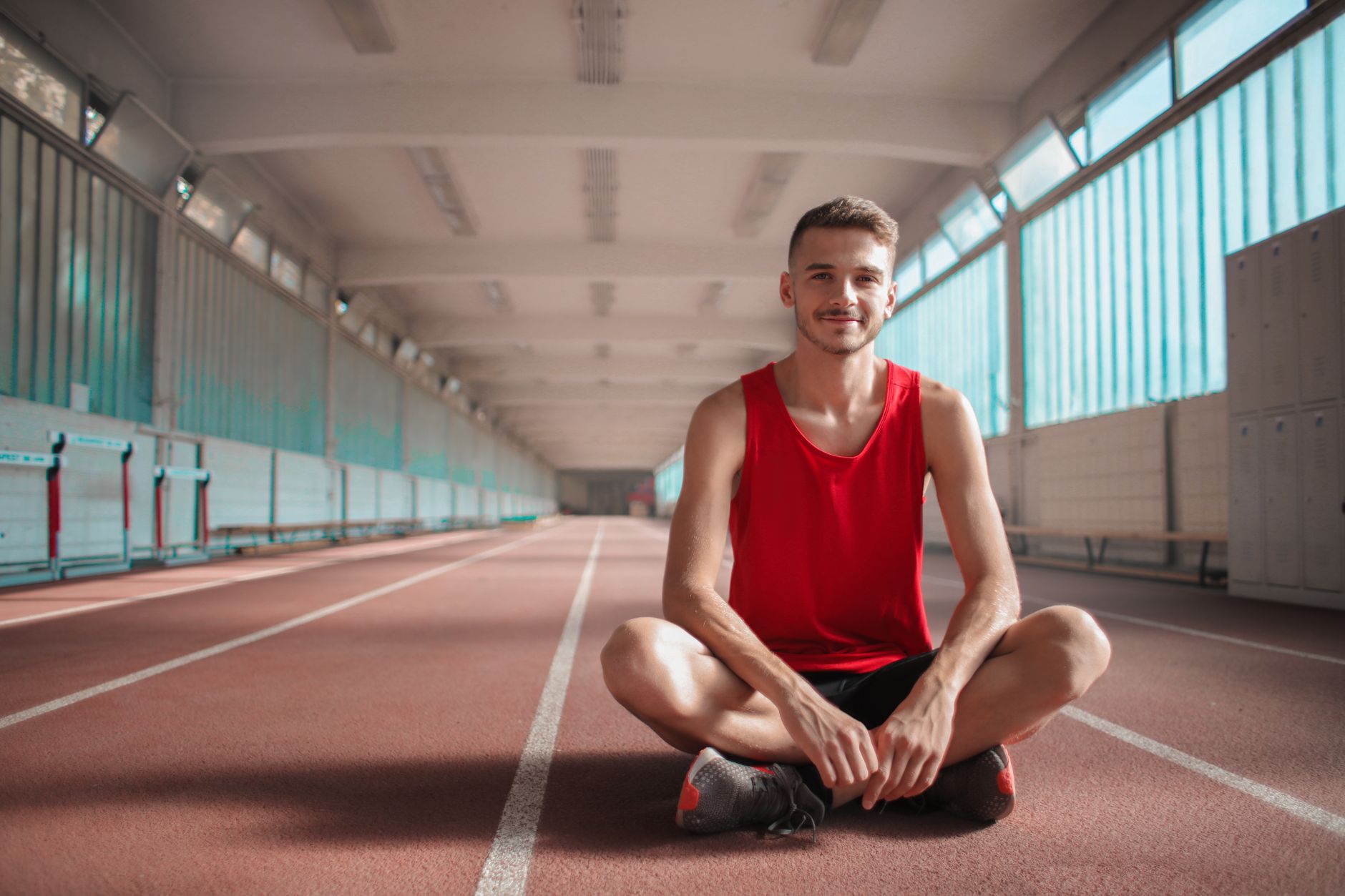 Athlete practising breathwork for athletes on a running track