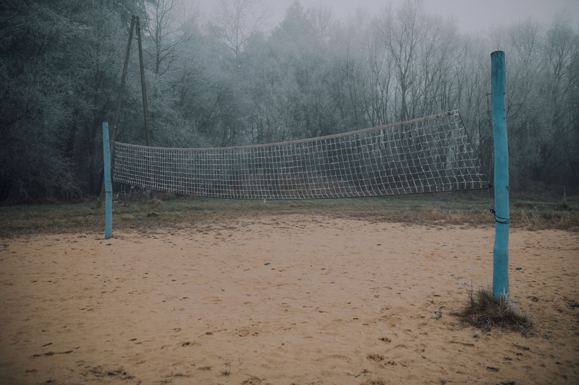 Beach volleyball court sand surface close-up showing fitness demands of the sport